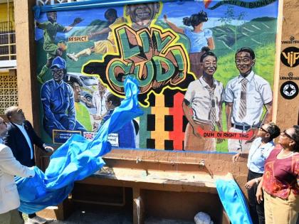Christopher Tufton (second left), and Andrew Bowden (left), unveil the LIV GUD mural at Haile Selassie High School in Kingston, during the launch of the Wellness Express – Adolescent Mental Health Mobile Service. Looking on are Juliet Cuthbert Flynn (sec