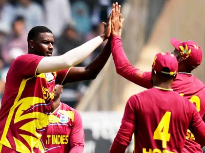 West Indies’ Jason Holder (left) celebrates with teammates after taking the wicket of Nepal’s Aarif Sheikh (not in photo) during the T20 World Cup cricket match in Mumbai, India, on Sunday.
