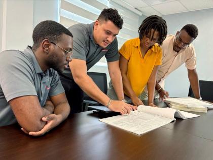 MEP coordination review by designers (from left): Dwight Simpson (electrical), Spencer Logan (electrical), Shenelle Tyrell (mechanical), and Josh Walters (electrical).