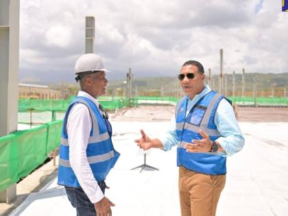 Prime Minister Dr Andrew Holness (right), speaks with Factories Corporation of Jamaica (FCJ) Chairman, Lyttleton Shirley, during a tour of the Morant Bay Urban Centre in 2024. 