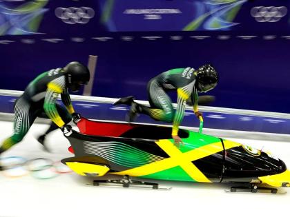 Jamaica’s Shane Pitter (right) and Junior Harris start for a two-man bobsled run at the 2026 Winter Olympics in Cortina d’Ampezzo, Italy, on Monday.