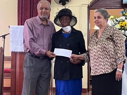 Paul Thorbourne (left) and Cynthia Burton (right), former trustees of the Mavis Fraser-Davis Trust, present a cheque for $1.3 million to Hermina Reid of the Bethlehem Moravian Church in Malvern, St Elizabeth, on February 1.