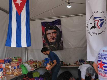 A volunteer arranges supplies at an aid collection center for Cuba in Mexico City's Zocalo on February 16, 2026. 
