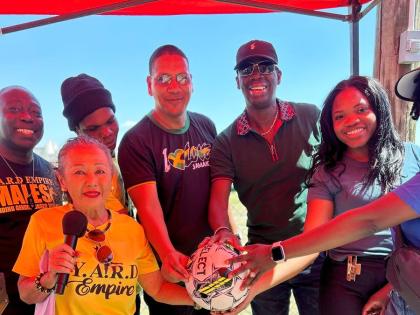 Member of Parliament for Central Kingston Donovan Williams (centre) holds a football alongside Peace Cup sponsor and creative strategist at YARD Empire Iris ‘Terri’ Salmon (front row, left) and other stakeholders ahead of kick-off for the Ash Wednesday