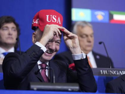 
Giovanni Vincenzo Infantino, president of FIFA, tries out a USA hat during a Board of Peace meeting at the US Institute of Peace on Thursday.