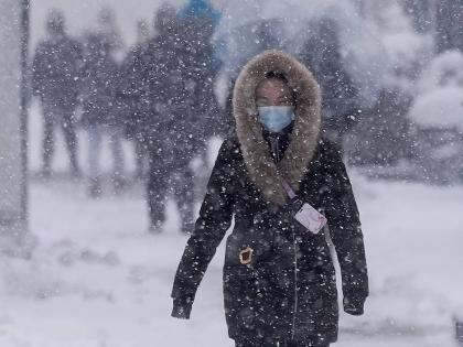 A man walks along the Hudson River Greenway in lower Manhattan during a snow storm, on February 23, 2026, in New York. 