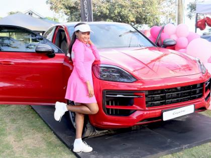  Anika Lake Francis, founder of the Jamaican Women’s Golf Network, strikes a playful pose next to a 2024 Porsche Cayenne.