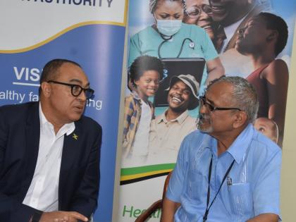 Health and Wellness Minister Dr Christopher Tufton (left) and Dr Delroy Fray, clinical coordinator, Western Regional Health Authority, converse during a press briefing at the WRHA’s offices in Montego Freeport on Thursday.