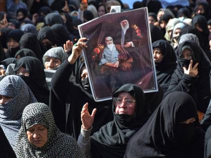 Shiite Muslims hold the portraits of Iranian leaders during a rally to condemn the killing of Iranian Supreme Leader Ayatollah Ali Khamenei, in Quetta, Pakistan, on March 1, 2026. 