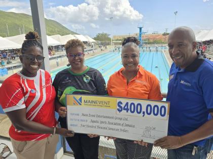 Jamaica’s coach and manager, Gillian Millwood and Georgia Sinclair (left and second left, respectively) are presented with a $400,000 sponsorship cheque by Main Event Entertainment Group’s Donna Stuart (second right) and Glendon Phillips (right) for th