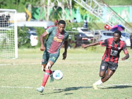 Montego Bay United’s Philando Wing (left) tries to outrun Arnett Garden’s Ranoldo Lawrence during their Jamaica Premier League game at Jarrett Park in Montego Bay yesterday.