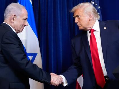 President Donald Trump shakes hands with Israel’s Prime Minister Benjamin Netanyahu during a news conference at Mar-a-Lago, in December 2025 in Palm Beach, Florida. 