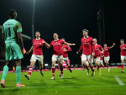 Wrexham’s goalkeeper Arthur Okonkwo (left) celebrates with teammates after a penalty shootout at the end of the English FA Cup third round  match between Wrexham and Nottingham Forest in Wrexham, Wales, on January 9, 2026. 