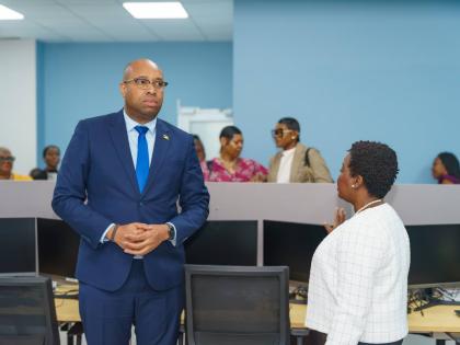Delano Seiveright (right), state minister in the Ministry of Industry, Investment and Commerce, listens as Gloria Henry, vice-president of BPO and Logistics at the Port Authority, makes a point during a tour following the launch of the Portmore Incubator a