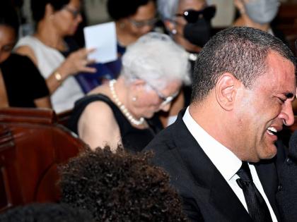 Jolyan Silvera sheds tears as he sits with his sons at the funeral service for his late wife Melissa Silvera at the St Andrew Parish Church on January 12, 2024.  (Rudolph Brown/Photographer)