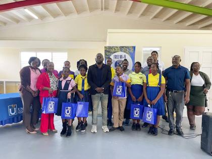 Member of Parliament for St Mary South Eastern, Christopher Brown (centre), poses with several of the awardees and their teachers. 