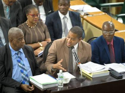 Minister of Agriculture, Fisheries and Mining, Floyd Green, responds to questions during the sitting of the Standing Finance Committee at Gordon House on Friday, March 6. He is flanked by State Minister, Franklin Witter (left) and Permanent Secretary in th
