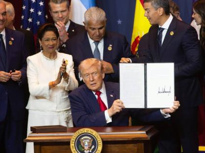 United States President Donald Trump is joined by Trinidad and Tobago Prime Minister Kamla Persad-Bissessar at the signing ceremony for the agreement establishing the military alliance known as the Americas Counter-Cartel Coalition.