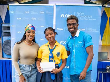 Digital storyteller and creative entrepreneur, Tanaania Tracy, and LeVaughn Flynn, director of the Flow Foundation, present a Samsung tablet to a student of Marcus Garvey Technical High School for her participation in Flow’s Internet safety promotional e