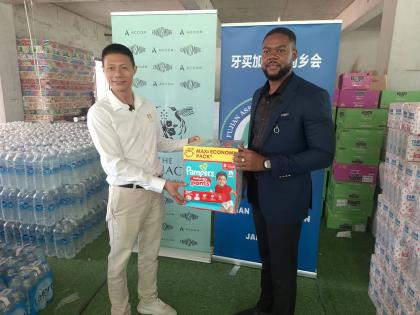 Yangsen Li, vice-president of the Fujian Association of Jamaica, presents hurricane relief supplies on behalf of the Chinese business community in Guadeloupe to Richard Vernon Jr, mayor of Montego Bay.