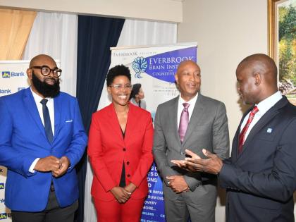 Dr O’Neil Dacres (right), corporate relations manager at JN Bank, has the captive attention of husband and wife and co-founders of Everbrook Brain Institute and Cognitive Clinic, Dr Steve Lawrence (left), a technology, curriculum, eLearning, AI and resea