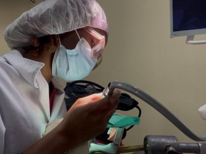 Jade Cohall-Cunningham demonstrates cavity preparation and restoration on a dental mannequin during her clinical practice.