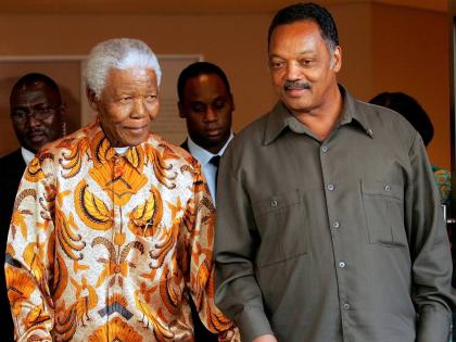 Nelson Mandela, left, walks with the Rev. Jesse Jackson after their meeting in Johannesburg, South Africa, in October 2005.