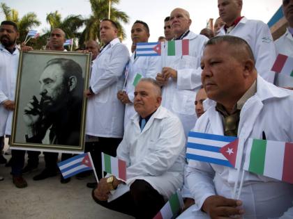 In this 2020 photo, Cuban doctors and medical professionals are seen at the Havana airport prior to their departure to Italy to assist with the COVID-19 pandemic.