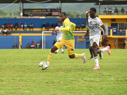 Navardo Blair (left) of Treasure Beach tries to outrun Cavalier’s  Jerome McLeary during their Jamaica Premier League game at St Elizabeth Technical Sports Complex yesterday. Cavalier won 1-0.