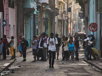 People line up in the street to buy bread in Havana, Cuba, Friday, March 13, 2026. 