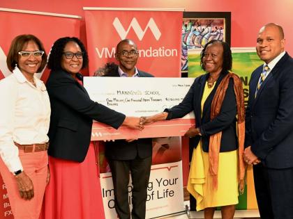 Fiona Vassell-Kerr (2nd left), vice-principal of the Manning’s School, accepts a symbolic cheque from Pastor Claudia Ferguson (2nd right), chairperson of the National Leadership Prayer Breakfast Committee. Sharing in the moment is Samantha Charles (left)