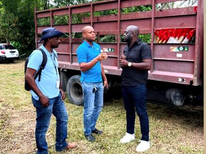 Rural Agricultural Development Authority (RADA) Parish Manager Kashief Smith (centre) makes a point to Christopher Brown (right), member of parliament for St Mary South Eastern, as RADA Extension Officer Kavil Howard (left) looks on.