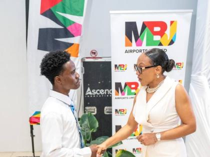 Sharon Heslop-Holt, manager of commercial business development and marketing at MBJ Airports Limited, greets Damario Hutchinson, one of the tertiary beneficiaries of the MBJ Foundation Charity Run/Walk Grant.