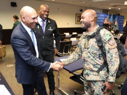 Major General (Ret’d) Antony Anderson (left), Jamaica’s ambassador to the United States and permanent representative of Jamaica to the Organization of American States, greets Jamaica Defence Force Lieutenant Colonel Zavian Phipps (right), a participant