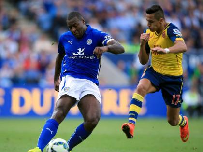 Leicester City’s Wes Morgan plays a pass as he comes under pressure from Arsenal’s Alexis Sanchez (right), during their English Premier League football match at the King Power Stadium, Leicester, England, Sunday, August 31, 2014. 