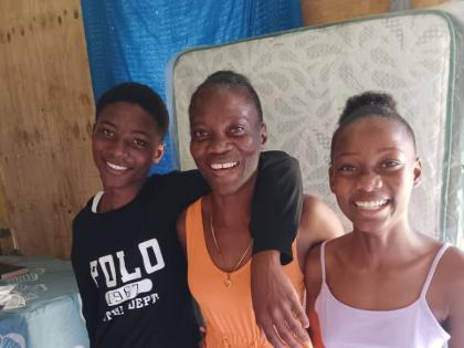 Natalee Watson (centre) and the two children who live with her, Ethon Jackson and Rosetta Jackson. 