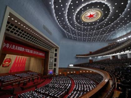 A screen shows Chinese President Xi Jinping as Premier Li Qiang delivering his work reports during the opening session of the National People’s Congress (NPC) at the Great Hall of the People, in Beijing.
