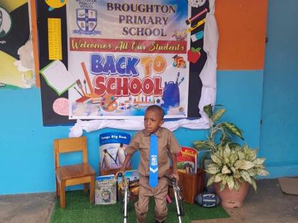 Keneil Parkinson moves around the school compound with the aid of his walker.