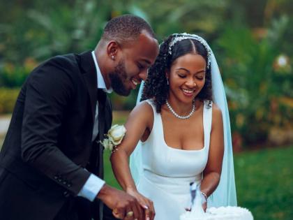 Mr and Mrs Thomas share a sweet moment cutting their cake, courtesy of Lola’s Dessert.