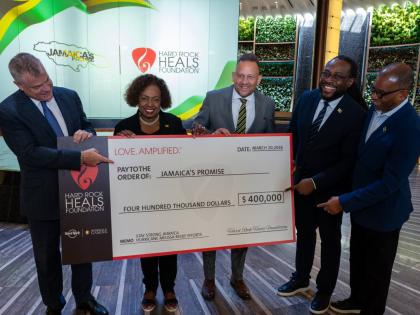 Minister of Culture, Gender, Entertainment and Sport Olivia Grange (second left) is joined by David Hoenemeyer, chief operating officer of Seminole Gaming (left), and Jamaica’s Consul General to Miami Oliver Mair (third right), for a ceremonial cheque ha