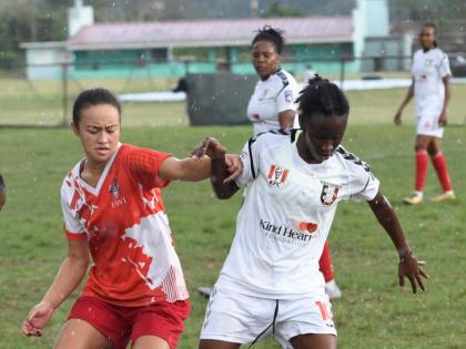 Caitlyn Sams of UWI Women’s FC (left) challenges Suen Gregory of Arnett Gardens FC during a Jamaica Women’s Premeir League football match at the UWI Mona Bowl in Kingston on March 14.