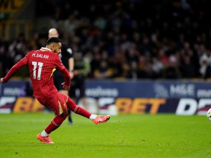 Liverpool's Mohamed Salah scores his side's second goal of the game during an English Premier League football match against Wolverhampton Wanderers at the Molineux Stadium in Wolverhampton, England, Saturday, September 28, 2024.
