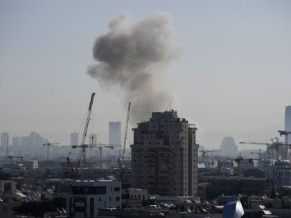 Smoke billows following an Iranian missile strike in Tel Aviv on March 24, 2026. (AP Photo/Ohad Zwigenberg)