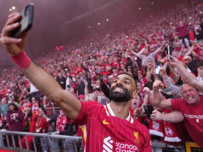 Liverpool’s Mohamed Salah celebrates by taking a selfie after winning the English Premier League football match against Tottenham Hotspur and clinching the Premier League title at Anfield in Liverpool, England on April 27, 2025.
