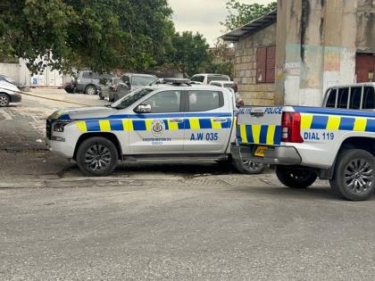 Police vehicles parked at a parking lot near Kingston Public Hospital, where officers are investigating a fatal shooting on March 25, 2026. 