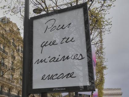 A poster featuring the French title of Celine Dion’s song ‘If That’s What it Takes’, promoting autumn concerts in France on the Champs-Élysées in Paris on Wednesday.