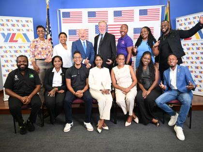 Charge d’Affaires Scott Renner (centre, standing) and United States Embassy Public Affairs Attaché, Mike Lavallee (third left, standing) are joined by YLAI alumni (back row) Latoya Rattary Ellis, Rachel Callaghan, O’Shane Ellis, Latoya West Blackwood 