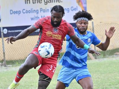 Montego Bay United’s Kimani Arbouine (left) controls the ball ahead of Molynes United’s Enrique Gordon in a Jamaica Premier League encounter at the Constant Spring Sports Complex yesterday. The game ended 1-1.