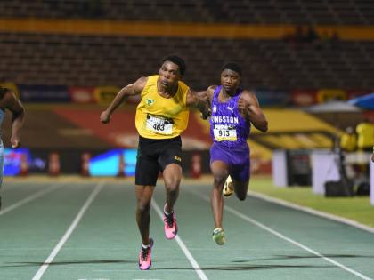 Excelsior High School’s Riquelme Reid dips at the tap to win the Class One boys’ 100m final at the ISSA/GraceKennedy Boys’ and Girls’ Athletics Championships at the National Stadium in Kingston on Wednesday night.