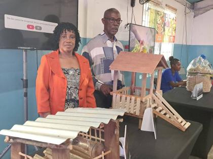 Kitson Town goat farmers Georgen Williams and Raymond Latibeaudiere, who are FAO beneficiary farmers, displaying a prototype of their goat house on March 26, 2026.